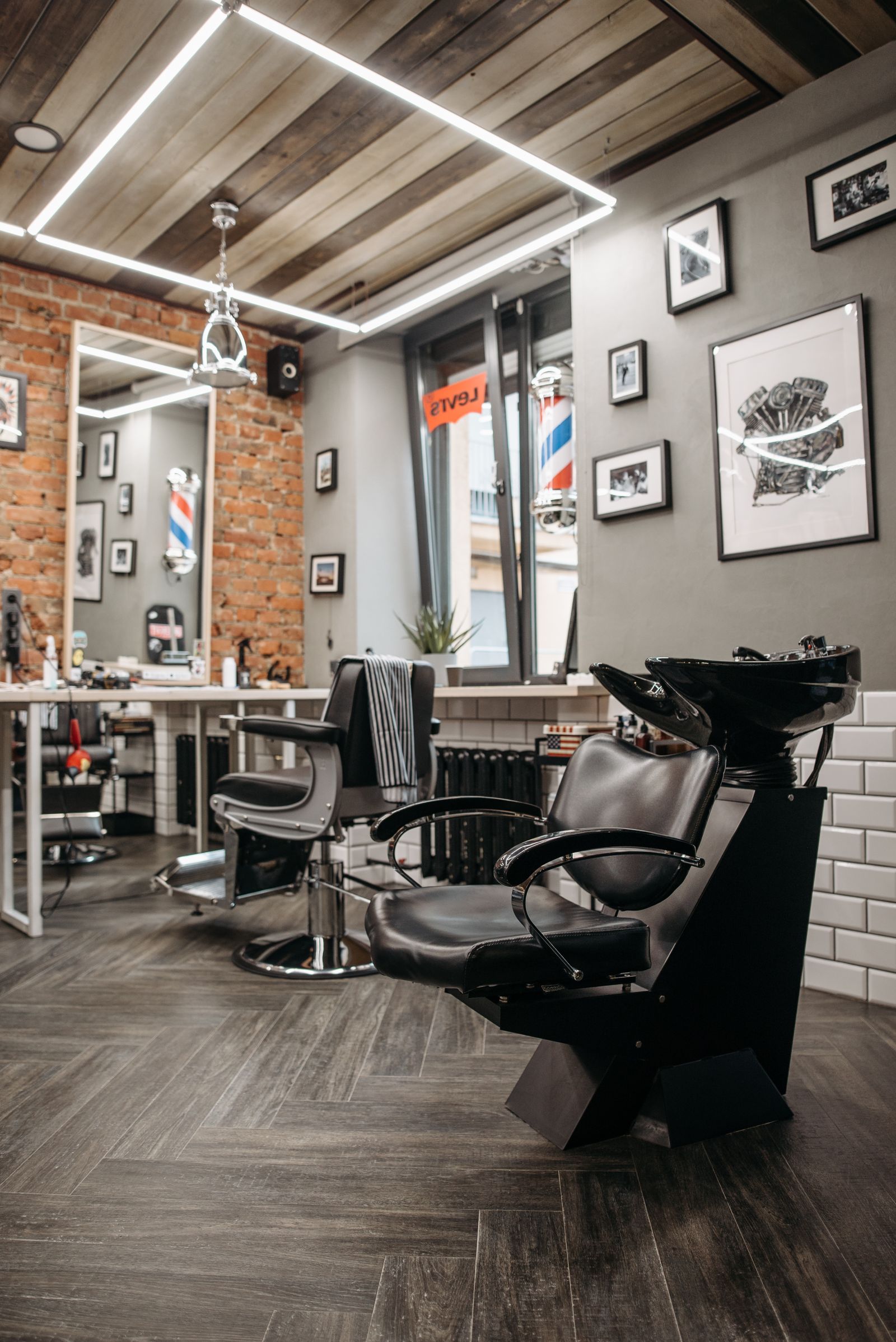Inside the shop - chairs, mirrors and the barber pole - replace images/about-main.jpg